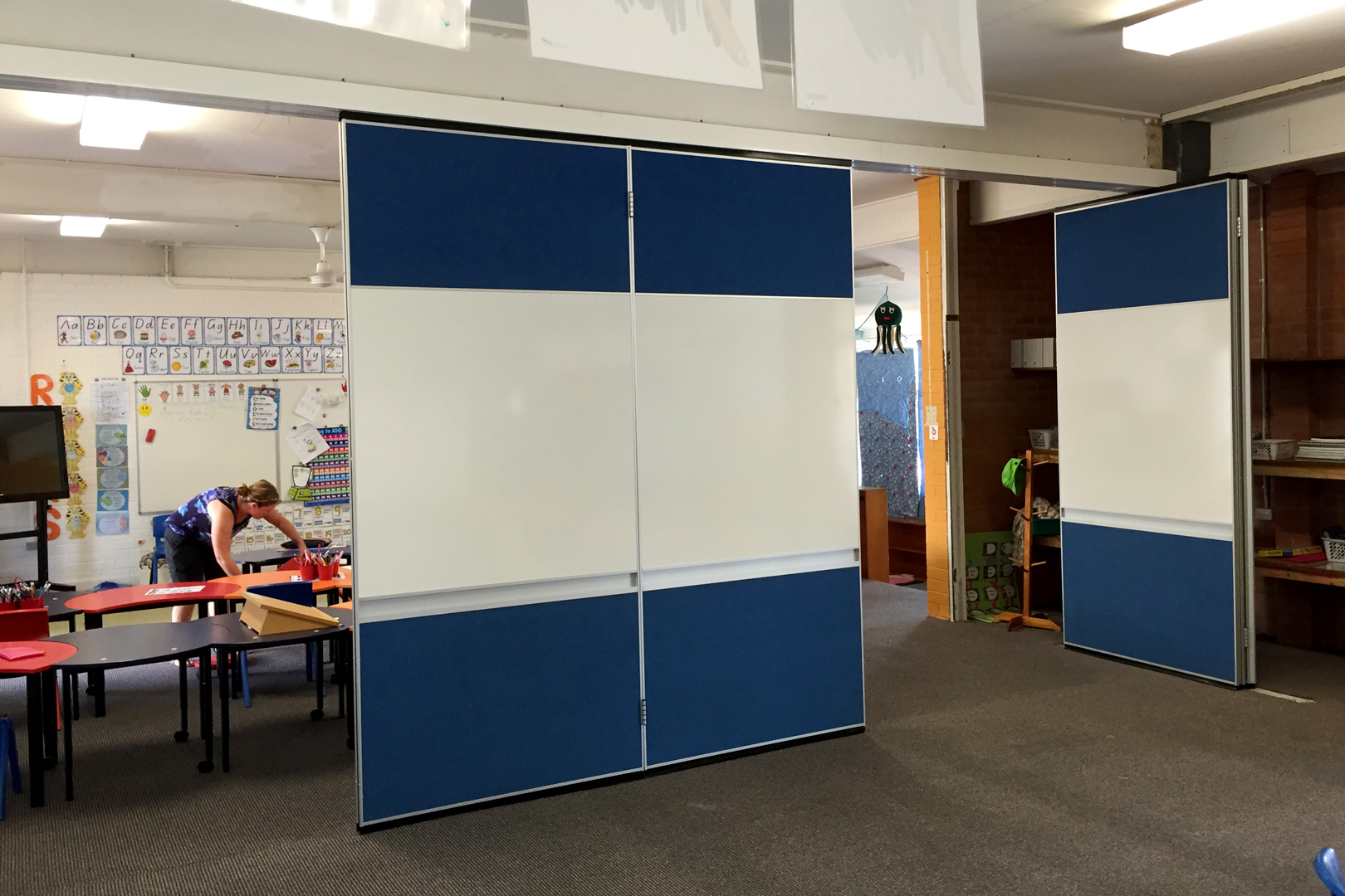 solid operable wall with inset whiteboard and pen rail