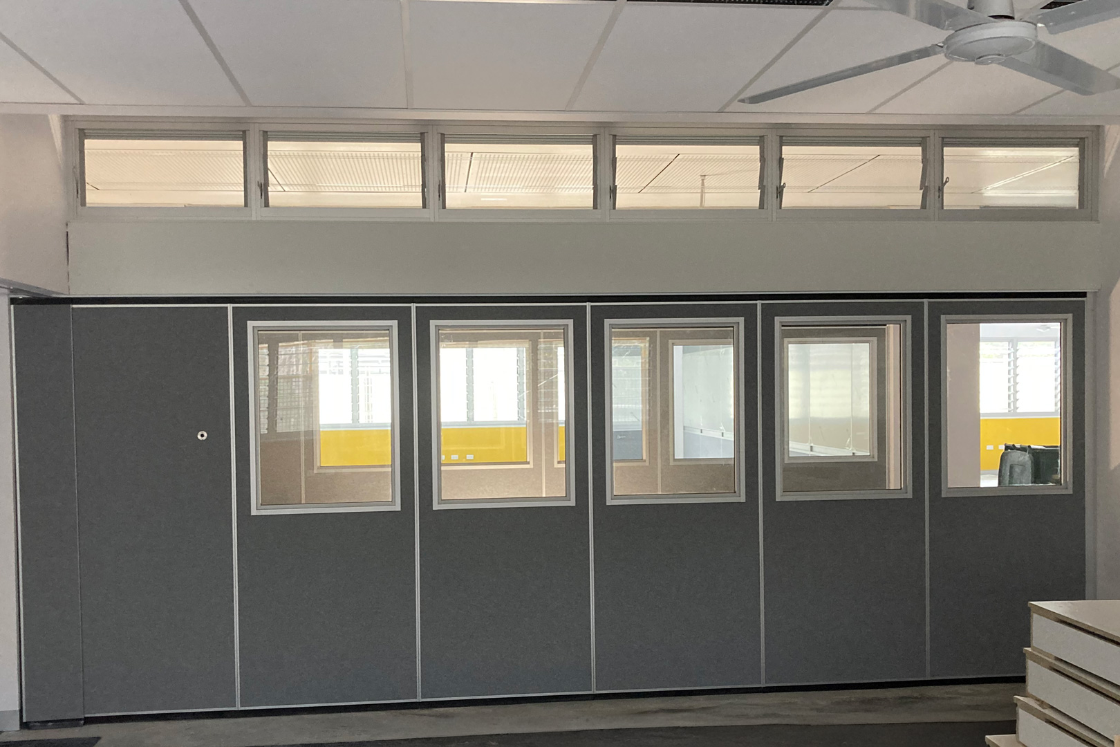 solid operable wall with inset windows and door