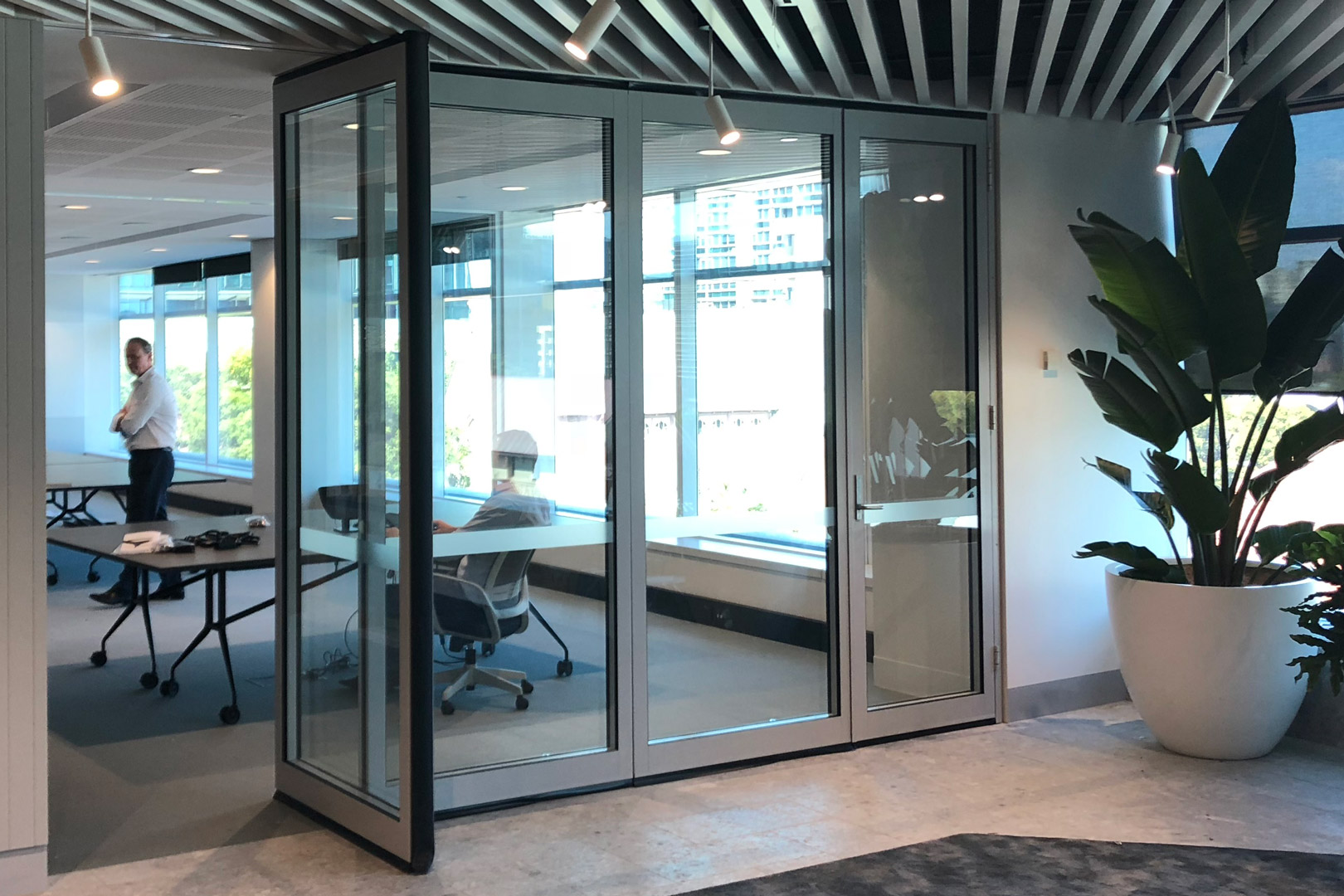 glazed operable wall for commercial fitout