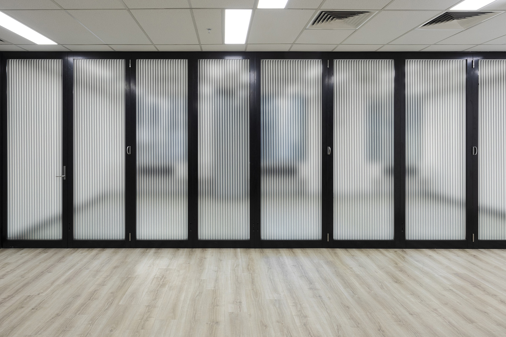 glazed operable wall with reeded glass